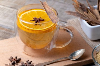 Papatya, tarçın, portakal ve anason çiçekleri karıştırılmış cam bardak..