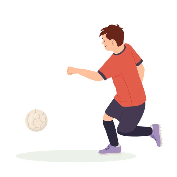 Stock vector Teenage boy football player, in a red sports shirt, kicks a soccer ball. Kid sportsman playing football game, dynamic practicing. Cartoon vector illustration in flat style isolated