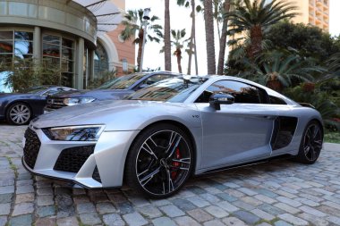 Monte-Carlo, Monaco - 16 Nisan 2023: Monte-Carlo, Monaco, Monaco 'daki lüks Monte-Carlo Bay Oteli' nin önüne park etmiş çarpıcı gri Audi R8 Coupe V10 performans dörtlüsü