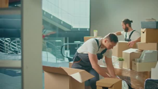 搬运公司的工人 穿着制服 小心翼翼地包装和搬运箱子 船务及包装业务职业服务公司 准备长途旅行 运送物品 — 图库视频影像
