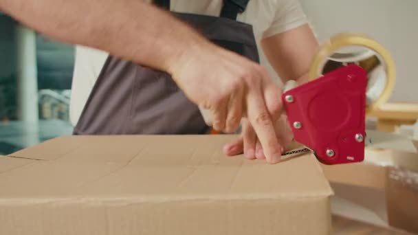 Close Employee Worker Sealing Cardboard Box Using Duct Tape Machine — Stock Video