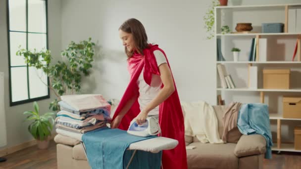 Happy Woman Housewife Super Hero Cape Dancing While Ironing Clothes — Stock Video