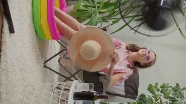 Vista Vertical Smiling Young Woman Beach Hat Resting Home Houseplants — Vídeo de Stock