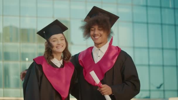 Portrait Two Positive Graduates Diplomas Hugging Together Rejoicing Diploma College — Stok Video