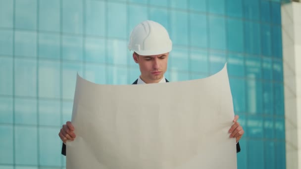 Male Engineer Architect Wearing Helmet Looking Construction Drawings His Hand — Stock Video