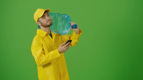 Green Screen Portrait Delivery Person Uniform Holds Big Bottle Water — Stok Video
