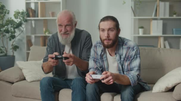 Young Elderly Man Happily Spending Time Playing Computer Game Joysticks — Stock Video