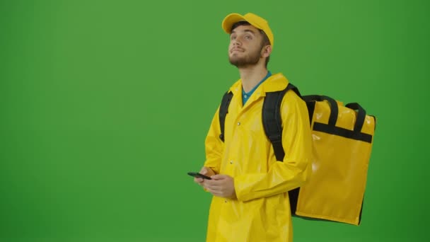 노란색 유니폼과 배낭과 스마트 사용하여 주문을 확인하는 고객에게 주문을 전달하는 — 비디오