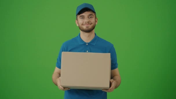 Green Screen Portrait Delivery Person Uniform Holds Cardboard Box Smiles — Stok Video
