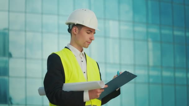 Male Engineer Architect Wearing Helmet Safety Jacket Looking Construction Drawings — Stock Video