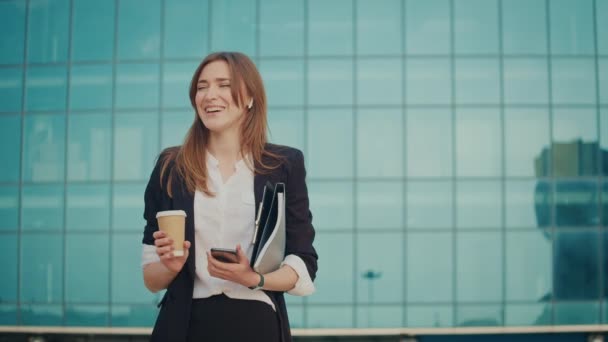 Happy Businesswoman Talking Cell Phone Using Headphones Holding Cup Coffee — Stock video