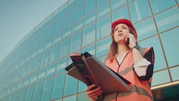 Young Woman Engineer Architect Wearing Orange Helmet Safety Jacket Talking — Stock Video