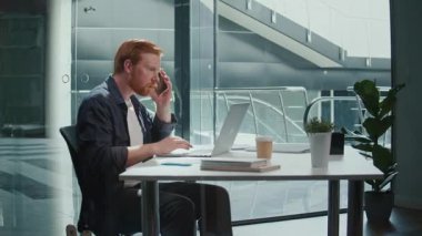 Ofis Minimalist Yaşam Tarzı, Dikkatli Çalışma, Estetik Odaklanma. Modern bir ofiste çalışan bir adam profesyonel bir telefon görüşmesi yapar. Sakin, Organize Odaklanma ve Basit Üretkenlik Sahnesi