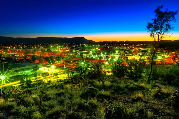 night aerial view of Alice Springs town in Australia from Anzac Hill Memorial lookout at twilight in Alice Springs city center. Located in Red Centre desert with Macdonnell ranges, Northern Territory