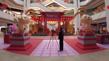 Sky Avenue mall, Kuala Lumpur, Malaysia - January 2023: shopping center is featuring golden bunnies and traditional Chinese pagodas for Chinese New Year of 2023, which is the Year of the Water Rabbit.