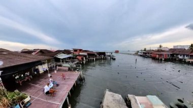 George Town, Malaysia - Jan 2023: aerial view of Chew Jetty ancient Chinese village on the sea. UNESCO-listed for ancient fisherman houses, lifestyle, graffiti art, and historical legacy of Chew Clan.