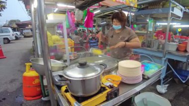 George Town, Malaysia - Jan 2023: street food noodless in Chew Jetty is an opportunity to experience the traditional flavors of the Chinese community that has lived in the area for generations.