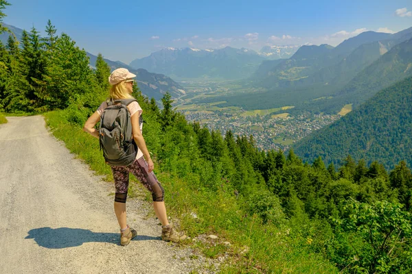 stock image Woman looking the top of Brambruesch in Switzerland. Swiss tourist resort of Chur or Coira town. Chur skyline in Grisons canton.