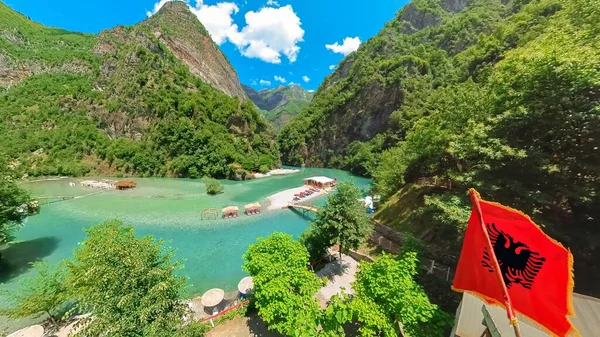 beautiful beaches scattered along the banks of the Shala River with Albanian flag. Idyllic spots offer chance to soak up the suns rays while enjoying the refreshing waters of this remarkable river.
