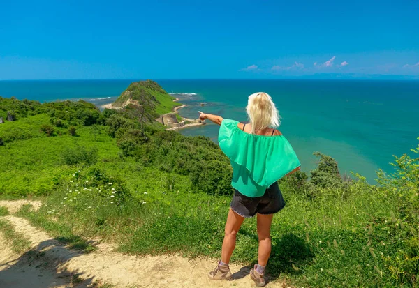 Woman tourist at Cape of Rodon in Albania. Albanian hero Skanderbeg built a castle on cape to defend against the Ottoman Turks. Rodon Castle was later used by Holy See of Vatican and French Empire.