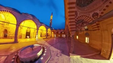 Geceleri, Türkiye 'nin Edirne kentindeki Uc Serefeli Camii' nin avlusu zarif minareler ve karmaşık kemerlerle yumuşak ışıkta yıkanarak Osmanlı mimarisinin ihtişamını ön plana çıkarıyor..
