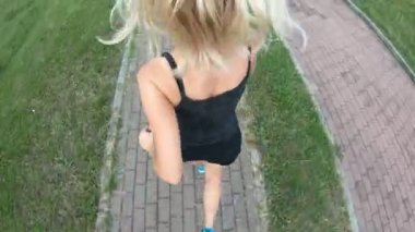 Spor kıyafetleri giymiş bir kadın, gün batımında parkta koşup sağlıklı bir yaşam tarzını gösterir. Formda bir kız koşucu kırsal bir yolda koşarken dışarıda kardiyovasküler egzersiz yaparken görülüyor.