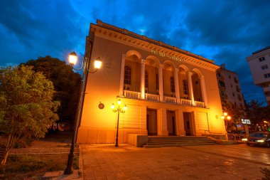 Shkoder, Arnavutluk - 1 Mayıs 2023: Şkodra şehir merkezi gece sokak manzarası. Teatri Migjeni Tiyatrosu.