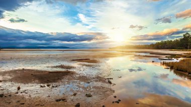 Daniels Bay at sunset, Lunawanna, Bruny Island, Tasmania, Australia. Clouds in the sky reflected on the water. clipart
