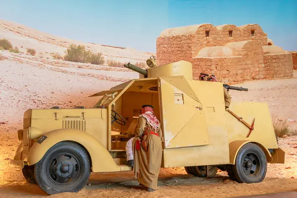 stock image Royal Tank Museum, Amman, Jordan - May 4, 2024: Historic British wagner armored car on display at the Royal Tank Museum in Jordan, with a mannequin dressed in traditional attire