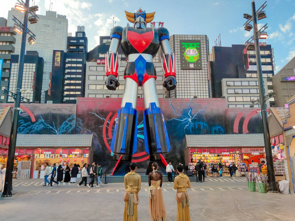 Riyadh,Saudi Arabia-Dec 25, 2025:Performers gazing at a giant Grendizer robot in the anime-themed zone of Riyadh Boulevard World, a global entertainment offering attractions and immersive experiences