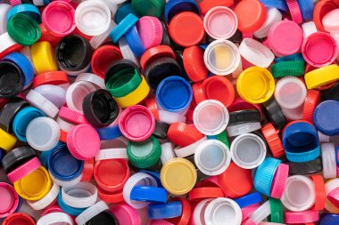 Background of plastic bottle caps. Material of the caps is recyclable. Sorting and recycling of plastic material. Environmental concept. High quality photo