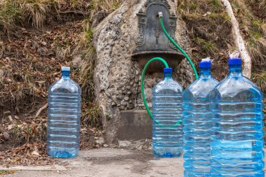 Plastic bottles ready to be filled with clean drinking water. Climate change. Drought. Water emergency. High quality photo clipart