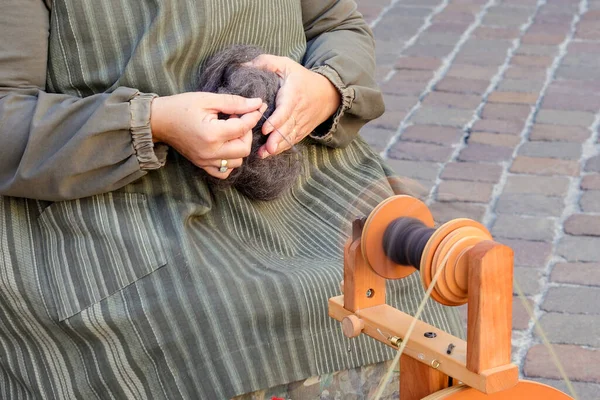 Women spinning yarn, close up. High quality photo