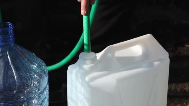 Ein Mann Füllt Plastikflaschen Mit Wasser Aus Einer Natürlichen Wasserquelle — Stockvideo