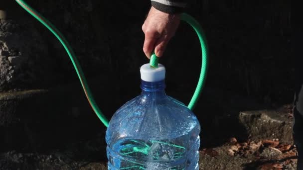Ένας Άνθρωπος Γεμίζει Πλαστικά Μπουκάλια Νερό Από Μια Φυσική Πηγή — Αρχείο Βίντεο