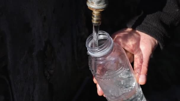 Man Fills Plastic Bottles Water Natural Water Source Mountains Concept — Stock Video