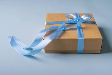 Stylish gift box on a blue background. There is space for text.