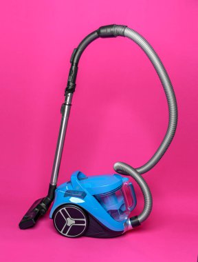 Vacuum cleaner on a pink background.