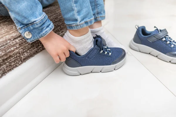 stock image Childrens hands on sneakers when putting on shoes. Close-up.