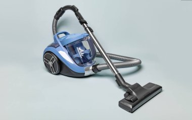 Vacuum cleaner on a neutral background. Cleanliness and cleaning.