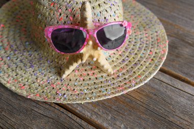 Şapkanın arka planında gözlüklü denizyıldızı. Yaz hala hayat.