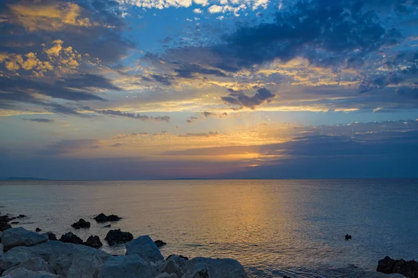 stock image A beautiful sunset on the sea is reflected in the water.