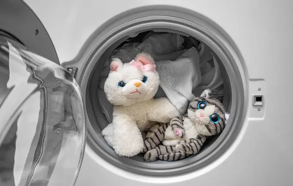 Washing soft toys in the washing machine along with laundry.