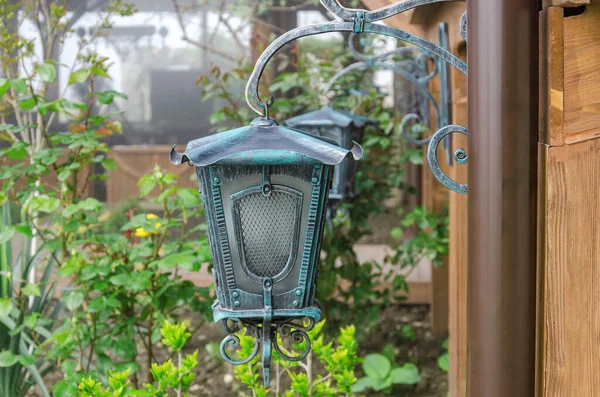 Retro lantern for outdoor lighting in the garden. Photographed during the day.
