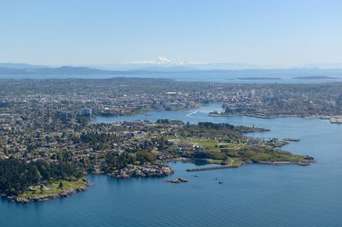 Aerial photograph of Victoria BC with Esquimalt located in the foreground. Mt Baker in Washington State is on the horizon, Victoria, Vancouver Island, British Columbi clipart