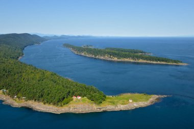 East Point Light station with Tumbo Island in the background, Gulf Islands National Park Reserve of Canada, Saturna Island, British Columbia, Canada. clipart