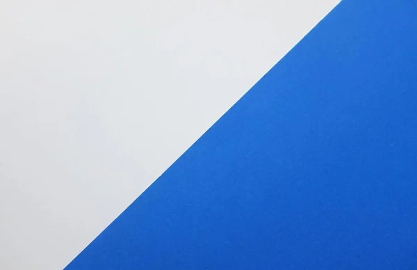two tone blue white paper color for background. Two color paper with Overlay on the floor And split half of the image. background.Top view with place for text