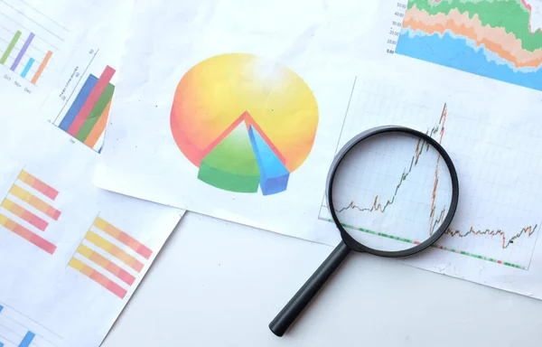 Stock image top view and copy space a  magnifying glass and graph charts document isolate on a white  background