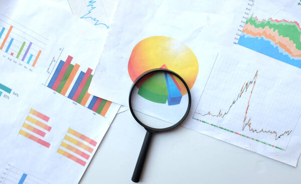 top view and copy space a  magnifying glass and graph charts document isolate on a white  background