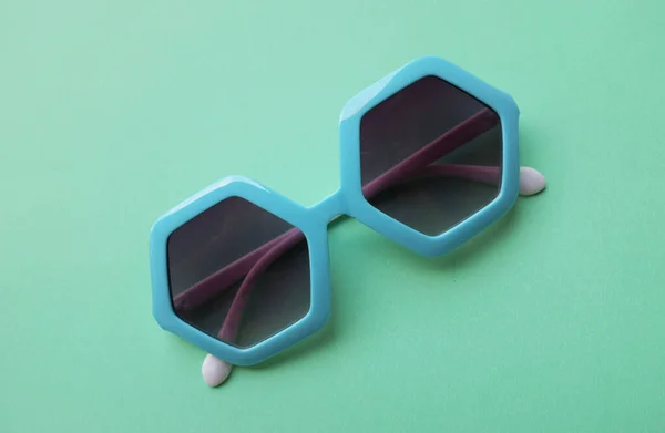Close Blue Pentagon Shape Sunglasses Isolate Green Pastel Background — Stock Photo, Image